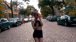 Exhibitionistic redhead girl is sucking a hard cock on the street