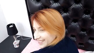 Ginger with a skinny figure is sucking on a sex toy