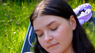 Blushy, small-tittied babe masturbates in the open air