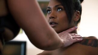 Milf licks the pussy of a black girl before using a strap-on